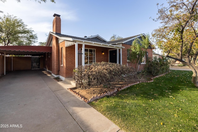 view of front of house with a front yard and a carport