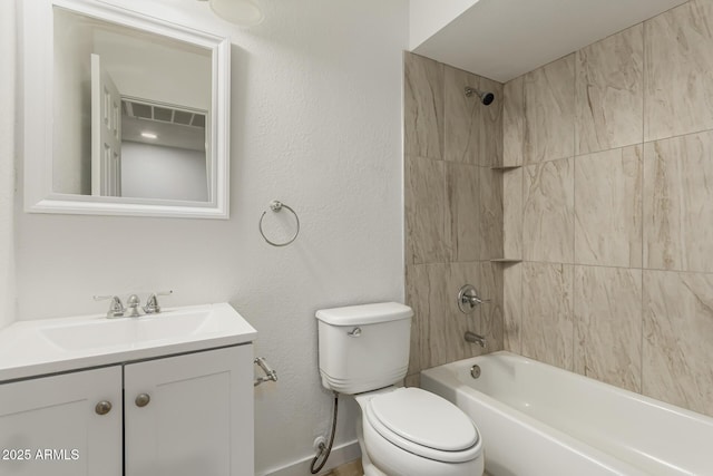 full bathroom featuring toilet, vanity, and tiled shower / bath