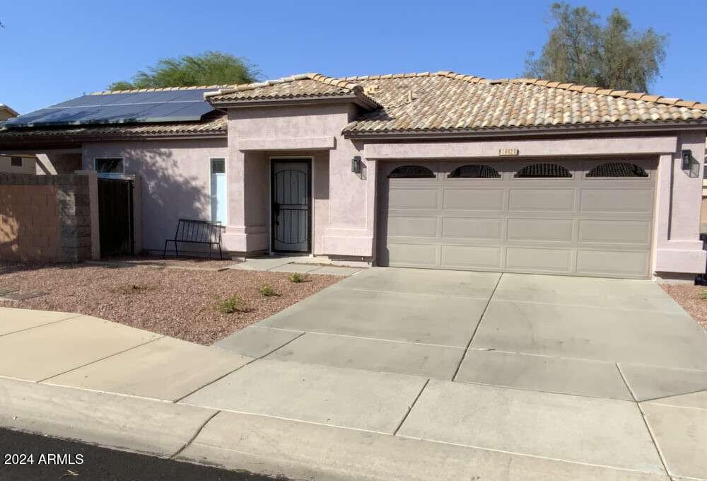 view of front of house featuring solar panels and a garage