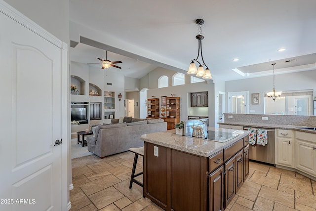 kitchen with stone tile floors, electric cooktop, stainless steel dishwasher, built in features, and ceiling fan with notable chandelier