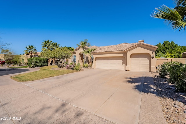 view of front of house with a tile roof, stucco siding, an attached garage, and concrete driveway