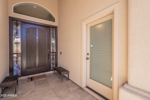 property entrance with stucco siding