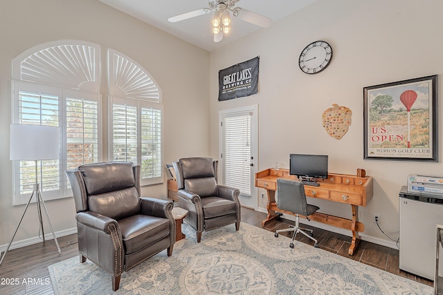 home office with baseboards, ceiling fan, and wood finished floors