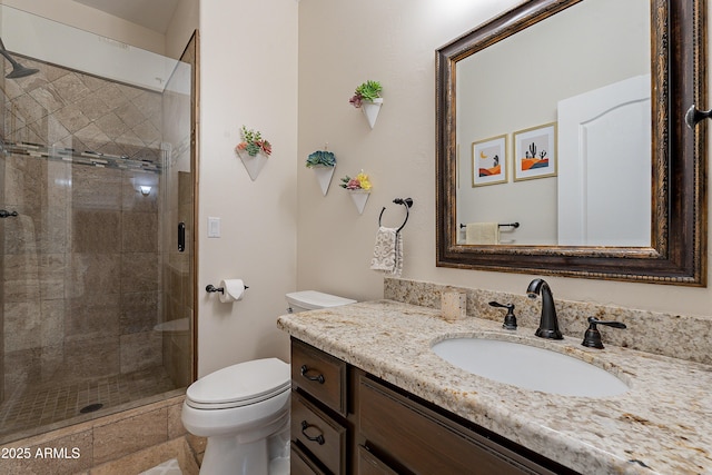 full bathroom featuring toilet, vanity, and a stall shower
