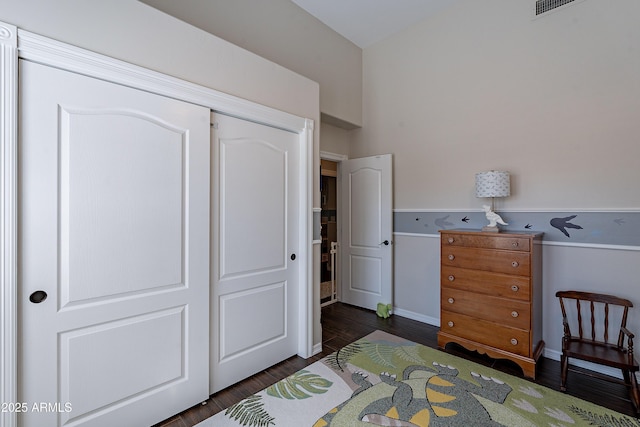 bedroom with a closet and dark wood-style floors