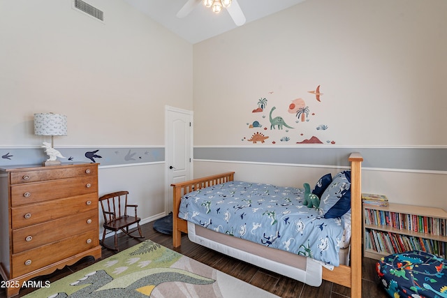 bedroom featuring lofted ceiling, visible vents, and wood finished floors