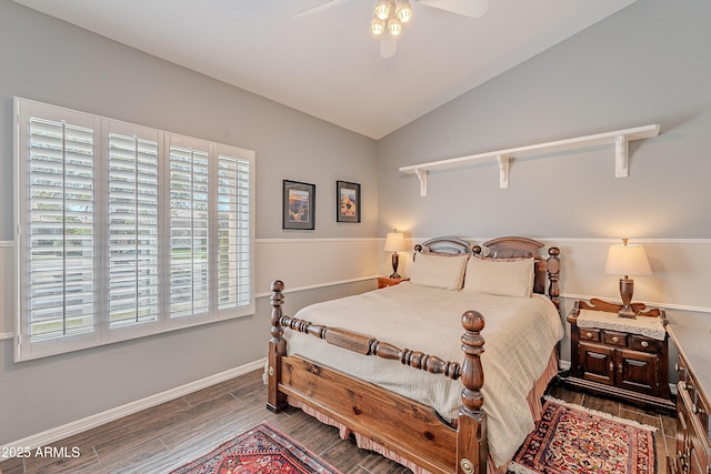 bedroom with a ceiling fan, wood finish floors, baseboards, and lofted ceiling