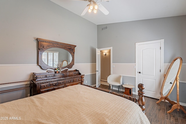 bedroom featuring wood finished floors, ceiling fan, vaulted ceiling, and visible vents