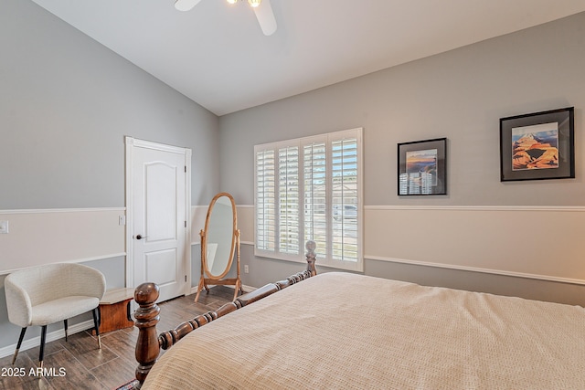 bedroom featuring baseboards, lofted ceiling, wood finished floors, and a ceiling fan