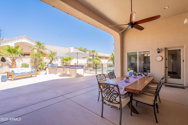 view of patio with a ceiling fan, a fenced in pool, fence, and outdoor dining space