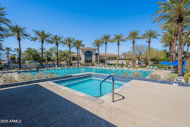pool featuring fence and a patio
