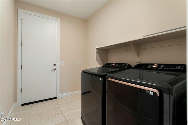 laundry area featuring washer and dryer and light tile patterned flooring