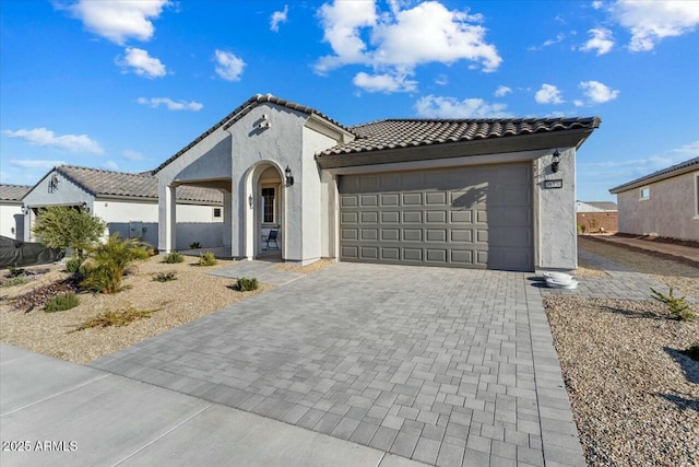 mediterranean / spanish home featuring a garage