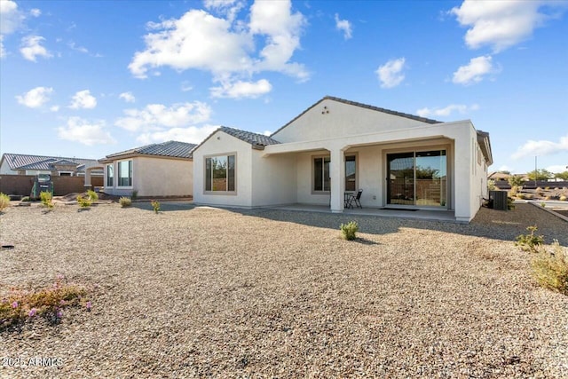 rear view of house featuring central AC unit and a patio area