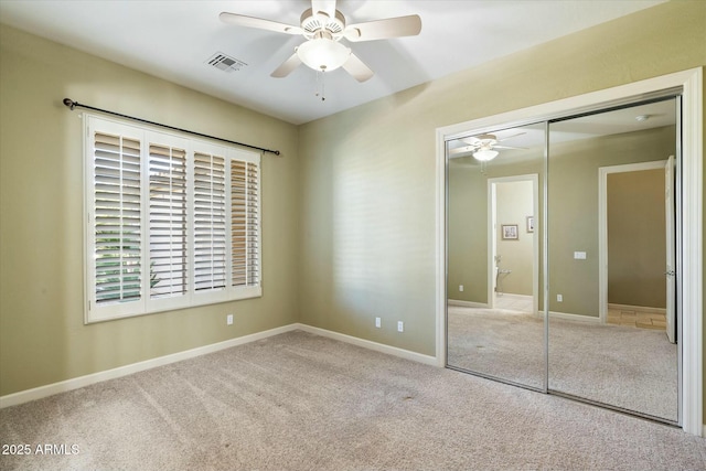 unfurnished bedroom featuring baseboards, a closet, visible vents, and carpet flooring