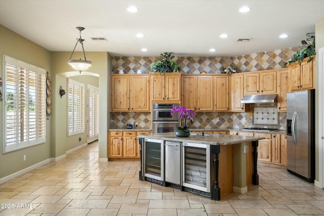 kitchen featuring stone tile floors, beverage cooler, visible vents, stainless steel appliances, and under cabinet range hood