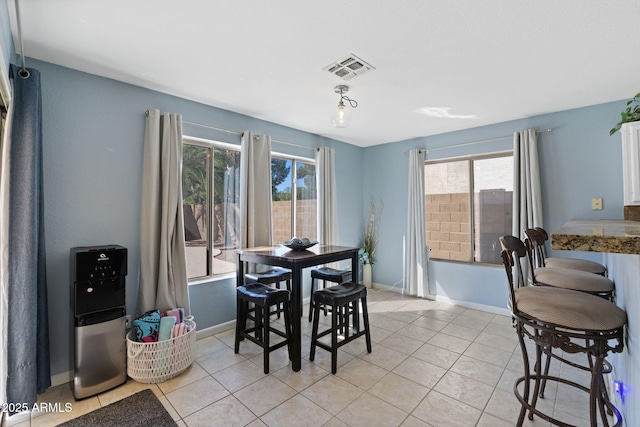 dining space with plenty of natural light and light tile patterned floors