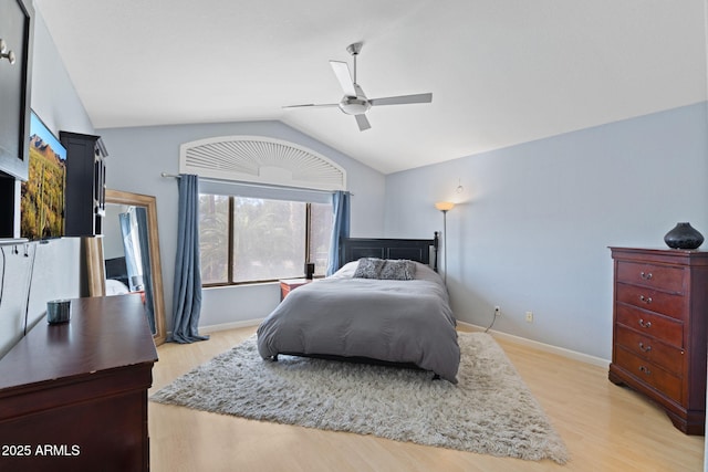 bedroom with hardwood / wood-style flooring, vaulted ceiling, and ceiling fan