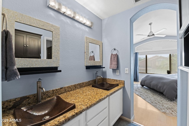 bathroom with ceiling fan and vanity