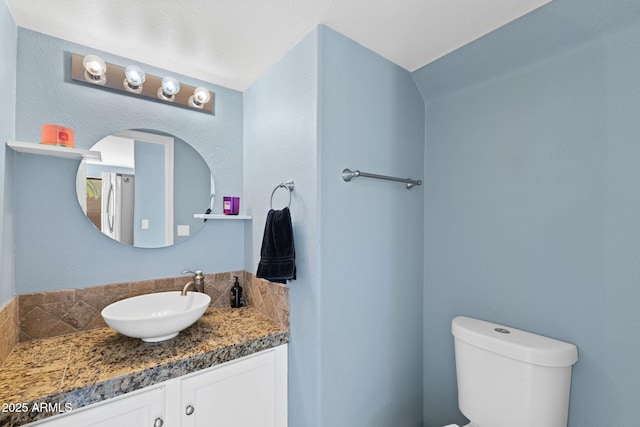 bathroom featuring toilet and vanity