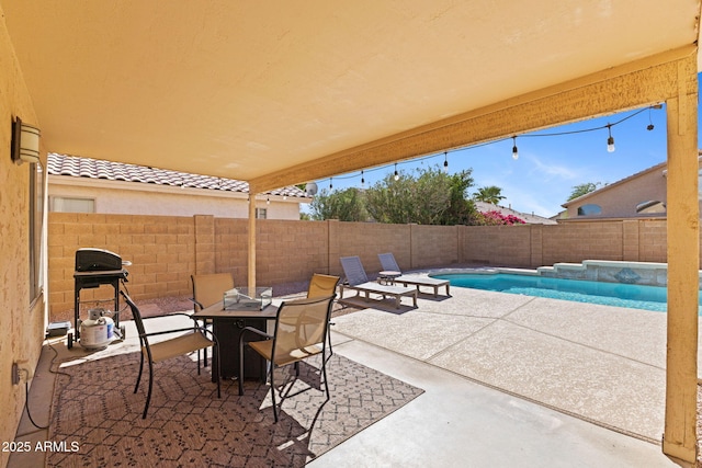 view of patio / terrace with a fenced in pool