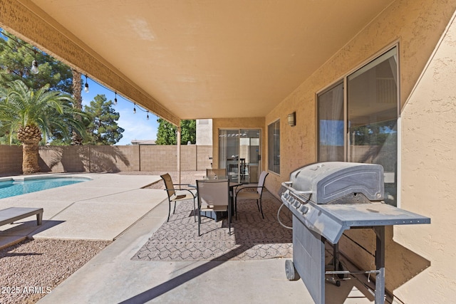 view of patio featuring a fenced in pool and a grill