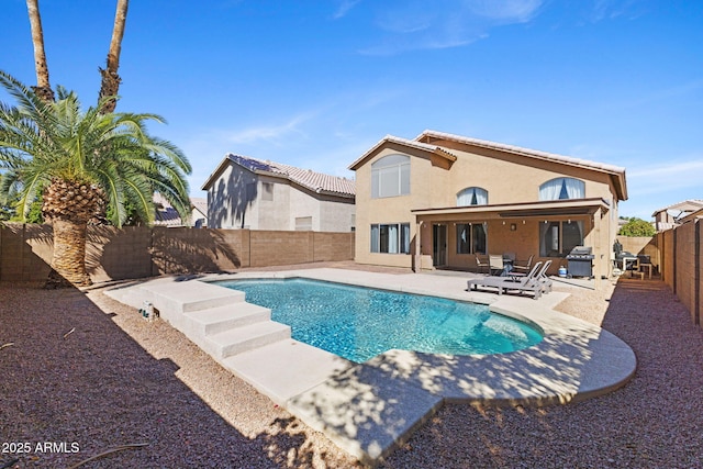 view of swimming pool featuring grilling area and a patio