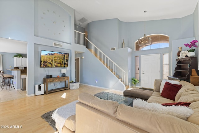 living room featuring a towering ceiling and wood-type flooring