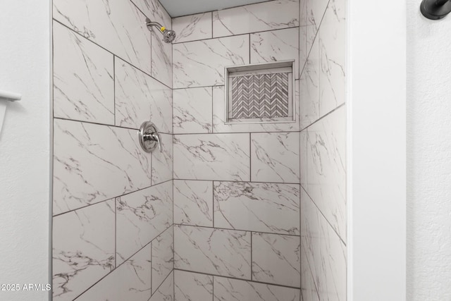 bathroom with a tile shower