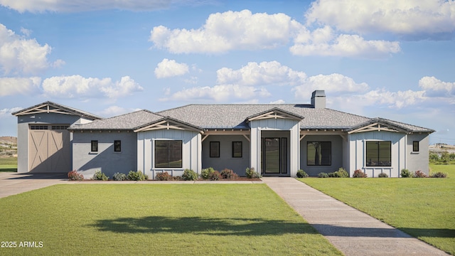 modern farmhouse featuring a chimney, a shingled roof, board and batten siding, and a front yard