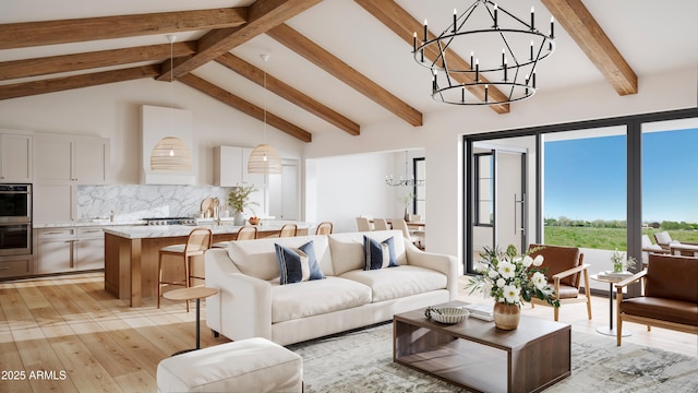 living room featuring a chandelier, beamed ceiling, high vaulted ceiling, and light wood finished floors