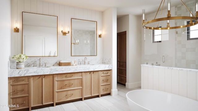 full bath with double vanity, a sink, a freestanding bath, and a shower stall