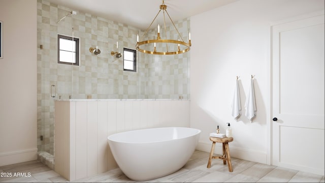 bathroom with a soaking tub, a shower stall, and an inviting chandelier