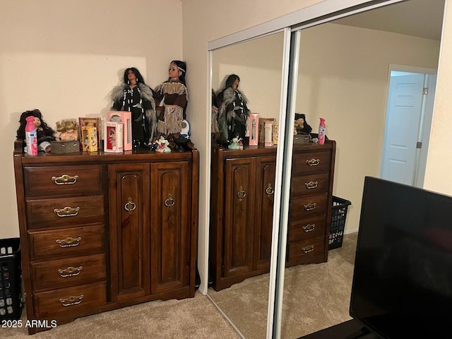 bedroom featuring light colored carpet and a closet