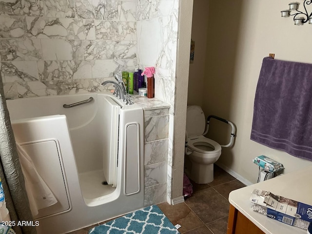 bathroom with a bath, tile patterned floors, and toilet