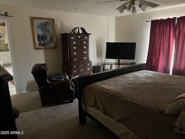 bedroom featuring ceiling fan and carpet