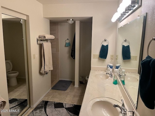 bathroom featuring tile patterned floors, toilet, and vanity