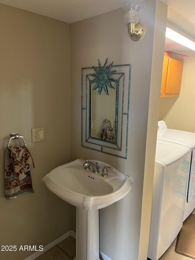 bathroom with washing machine and clothes dryer