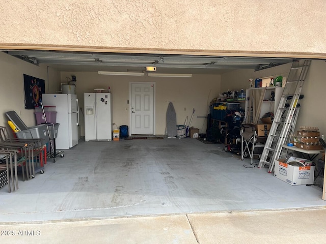garage with white refrigerator and white fridge with ice dispenser