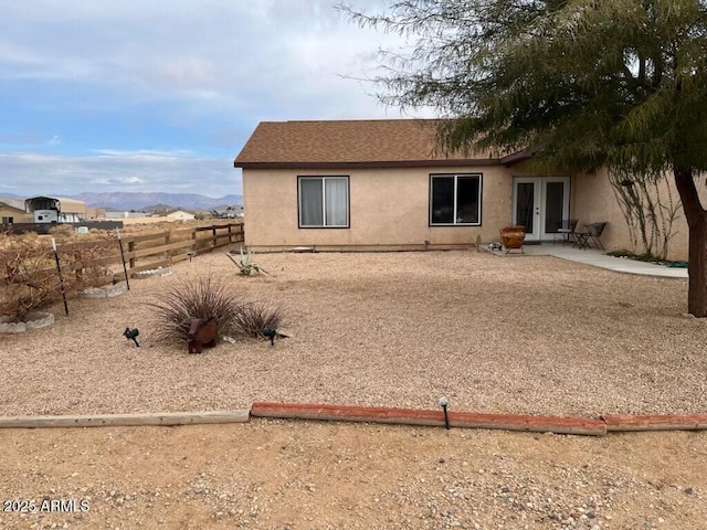 back of house featuring a mountain view, a patio area, and french doors