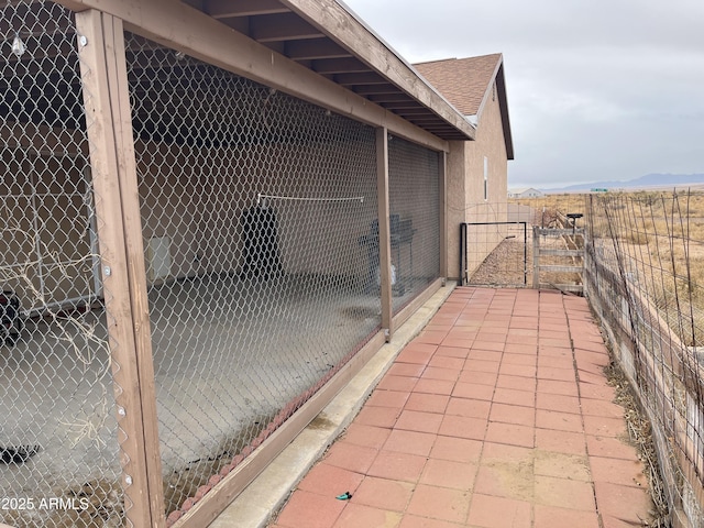 view of patio / terrace featuring a mountain view and an outbuilding