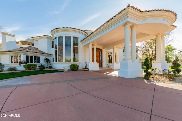 mediterranean / spanish home with a porch