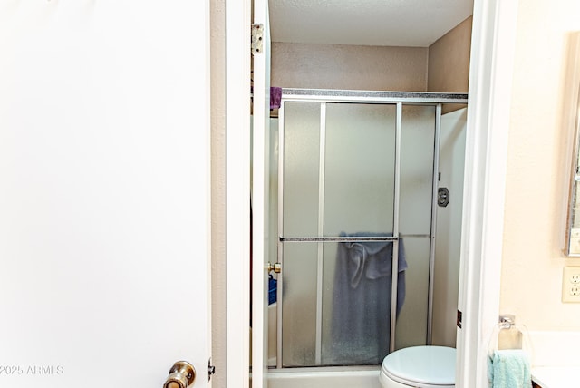 bathroom featuring toilet and walk in shower