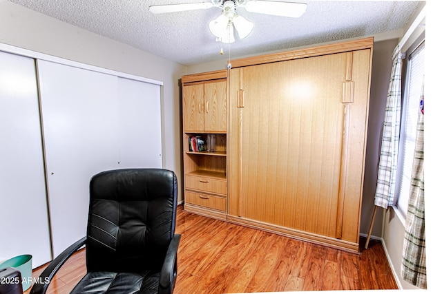 office space with ceiling fan, a healthy amount of sunlight, hardwood / wood-style floors, and a textured ceiling