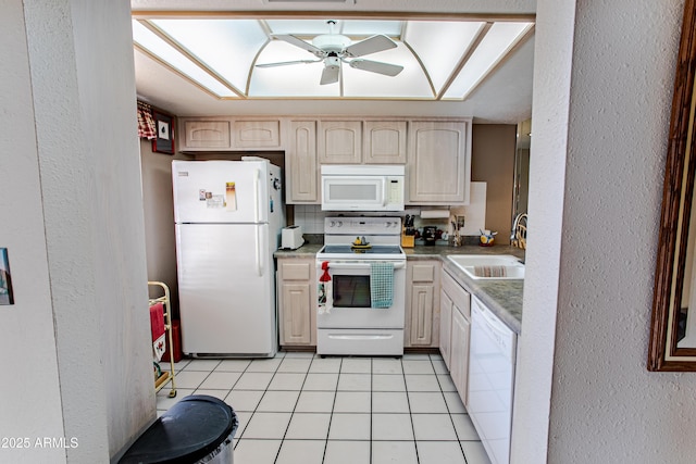 kitchen with sink, light tile patterned floors, ceiling fan, light brown cabinets, and white appliances