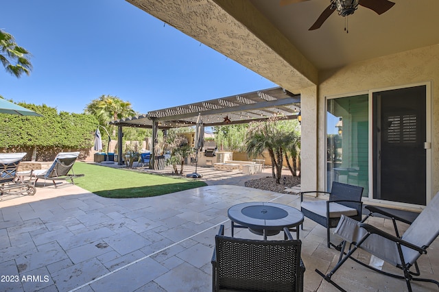 view of patio / terrace with ceiling fan, exterior kitchen, fence, and a pergola