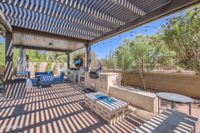 view of patio / terrace with a fenced backyard, a grill, an outdoor kitchen, and outdoor dining space