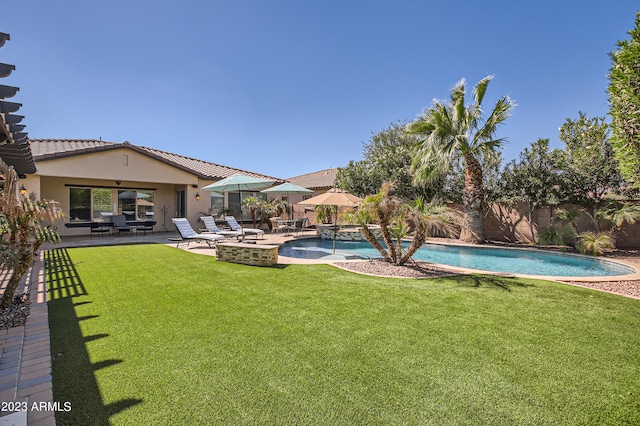 exterior space featuring a lawn, a patio area, a fenced backyard, and a fenced in pool