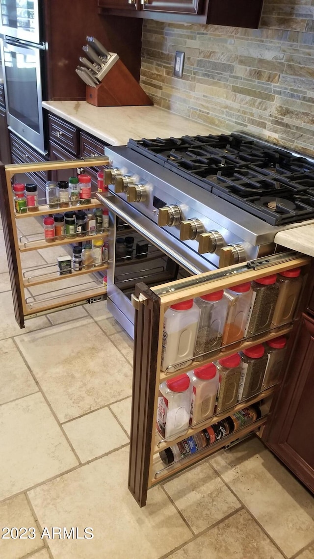 kitchen featuring light countertops, appliances with stainless steel finishes, and tasteful backsplash