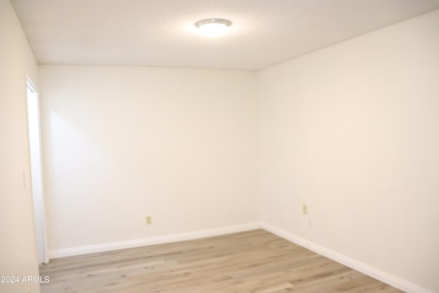 unfurnished room with light hardwood / wood-style floors